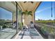 Cozy patio with seating overlooking the serene landscape and beautiful greenery at 20228 Lagente Cir, Venice, FL 34293