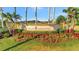 Elegant community entrance sign surrounded by colorful flowers and lush landscaping at 20228 Lagente Cir, Venice, FL 34293