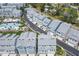 Aerial view of neighborhood showcasing community pool and colorful new townhomes at 2340 Lindstrom St, Sarasota, FL 34237