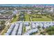 Expansive aerial view showcasing a community with a pool, clubhouse, and nearby park at 2340 Lindstrom St, Sarasota, FL 34237