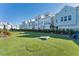 Lovely community backyard features a synthetic lawn with cornhole setup, offering a fun outdoor activity space at 2340 Lindstrom St, Sarasota, FL 34237