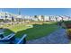 Gorgeous community backyard provides cornhole, a synthetic lawn, and plenty of space for outdoor games and relaxation at 2340 Lindstrom St, Sarasota, FL 34237