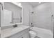 A well-lit bathroom features a tub with shower, neutral tile surround, and a modern vanity with sink at 2340 Lindstrom St, Sarasota, FL 34237