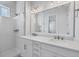 Modern bathroom with double sinks, quartz countertop, and walk-in shower at 2340 Lindstrom St, Sarasota, FL 34237