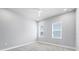 Clean bedroom with neutral walls, plush carpet, and two windows providing natural light at 2340 Lindstrom St, Sarasota, FL 34237