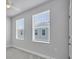 A cozy bedroom with two windows offering natural light and scenic exterior views at 2340 Lindstrom St, Sarasota, FL 34237