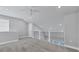 Bonus room with neutral paint, carpet and ceiling fan, with a railing overlooking the lower level at 2340 Lindstrom St, Sarasota, FL 34237
