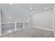 Bright bonus room with a ceiling fan, neutral paint, and a railing overlooking the lower level at 2340 Lindstrom St, Sarasota, FL 34237