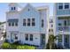 Charming two-story home featuring a blend of white and blue siding, complemented by lush greenery at 2340 Lindstrom St, Sarasota, FL 34237
