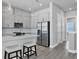 Bright, open kitchen with white cabinetry, stainless steel appliances, and a central island with bar seating at 2340 Lindstrom St, Sarasota, FL 34237