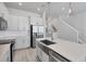 Modern kitchen featuring white cabinets, stainless steel appliances, and a large island with a sink at 2340 Lindstrom St, Sarasota, FL 34237