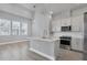 Well-lit kitchen featuring a central island, modern appliances, and sleek white cabinetry at 2340 Lindstrom St, Sarasota, FL 34237