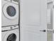 A bright laundry area with a Samsung stacked washer and dryer set, perfect for efficient space saving at 2340 Lindstrom St, Sarasota, FL 34237