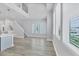 Open-concept living space with a modern kitchen and staircase at 2340 Lindstrom St, Sarasota, FL 34237