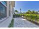 Spacious outdoor patio area surrounded by a black fence and manicured landscaping at 2340 Lindstrom St, Sarasota, FL 34237