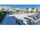 Stunning community pool featuring sun loungers, covered seating areas, and landscaping around multi-story townhomes at 2340 Lindstrom St, Sarasota, FL 34237