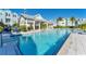 Inviting community pool with a zero entry, elegant pavilions, and perfectly situated palm trees at 2340 Lindstrom St, Sarasota, FL 34237