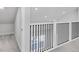 Modern staircase railing with a black metal spindles and white posts and rail at 2340 Lindstrom St, Sarasota, FL 34237