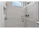 Shower with glass door, built-in shelving and tiled surround at 2340 Lindstrom St, Sarasota, FL 34237