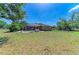 Expansive backyard featuring a screened-in patio area perfect for entertaining, with a pool, and lush landscaping at 2611 221St E St, Bradenton, FL 34211