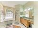 Bright bathroom with granite countertops, soaking tub, and glass shower stall at 2611 221St E St, Bradenton, FL 34211