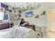 Cozy bedroom features ivy decor, a mounted TV, desk, and a comfortable bed at 2611 221St E St, Bradenton, FL 34211