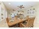 Open concept dining room showcasing a large wooden table and view into the kitchen and living area at 2611 221St E St, Bradenton, FL 34211