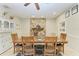 Dining room features a stone fireplace, neutral paint, ceiling fan and lovely decor at 2611 221St E St, Bradenton, FL 34211