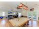 Bright game room with a pool table, hardwood floors, and natural light at 2611 221St E St, Bradenton, FL 34211