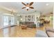 Open-concept living room with wood-look floors flows into the dining room and kitchen at 2611 221St E St, Bradenton, FL 34211