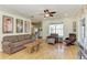 Comfortable living room featuring wood-look flooring, a ceiling fan, and ample seating with a cozy sofa at 2611 221St E St, Bradenton, FL 34211