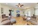 Inviting living room with an open layout, wood-look floors, comfortable seating, and lots of natural light at 2611 221St E St, Bradenton, FL 34211