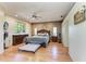 This spacious main bedroom features hardwood floors and a ceiling fan at 2611 221St E St, Bradenton, FL 34211