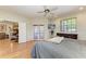 Bedroom featuring hardwood floors, a ceiling fan, and access to a covered patio at 2611 221St E St, Bradenton, FL 34211
