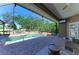 Inviting screened-in pool area with a relaxing waterfall feature and ample seating at 2611 221St E St, Bradenton, FL 34211
