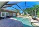 Sparkling pool area with a waterfall feature, outdoor seating, and a serene screened enclosure at 2611 221St E St, Bradenton, FL 34211