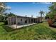 Lush backyard featuring a screened-in pool area, perfect for relaxation and outdoor entertaining at 3130 Key Way, Sarasota, FL 34239