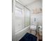 Bathroom features tiled walls, a window and bathtub with shower and white fixtures at 3130 Key Way, Sarasota, FL 34239