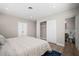 Bright bedroom features a closet, ensuite bath and a comfortable striped comforter at 3130 Key Way, Sarasota, FL 34239