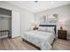 Bedroom features a large window, wood floors, and a bed with night stands and lamps at 3130 Key Way, Sarasota, FL 34239