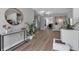 Stylish entryway with sleek console, mirror, and modern decor, leading to an open-concept living space at 3130 Key Way, Sarasota, FL 34239