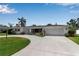Charming single-story home featuring a well-manicured lawn, circular driveway, and an attached two-car garage at 3130 Key Way, Sarasota, FL 34239