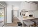 Modern kitchen featuring white cabinets, stone counter tops, stainless steel appliances, and barstool seating at 3130 Key Way, Sarasota, FL 34239