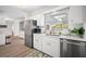 Updated kitchen with stainless appliances, tile backsplash, modern sink and faucet and beautiful window views at 3130 Key Way, Sarasota, FL 34239