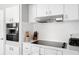 Bright kitchen with stainless steel appliances, white cabinets and a sleek, modern design at 3130 Key Way, Sarasota, FL 34239