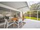 Screened patio area with stylish furniture, perfect for outdoor dining and relaxing at 3130 Key Way, Sarasota, FL 34239