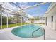 The covered pool area features a clean design with a bright white deck and a clear view of the blue sky at 3130 Key Way, Sarasota, FL 34239