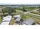 Aerial view of homes with manicured lawns, mature trees, a community lake, and pristine landscaping at 3333 26Th E Ave # 1004, Bradenton, FL 34208