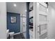 Nicely remodeled bathroom featuring a blue accent wall, decorative art, a stand-up shower, and storage at 3333 26Th E Ave # 1004, Bradenton, FL 34208