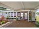 Inviting porch area with comfortable seating, double doors, and views of manicured landscaping at 3333 26Th E Ave # 1004, Bradenton, FL 34208